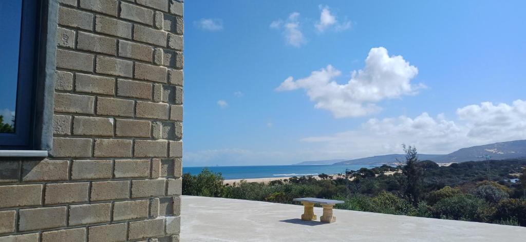 a bench sitting on the side of a brick building at Caslune in El Bidha