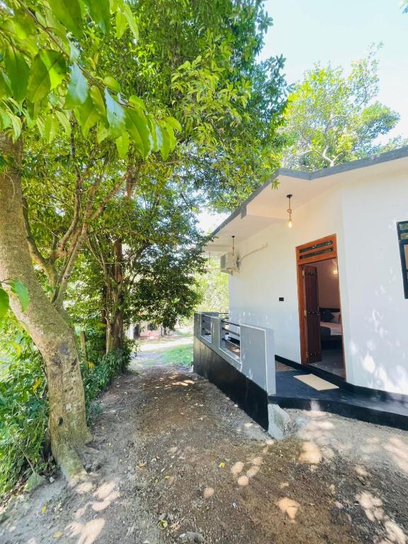 an external view of a house with a tree at Mond Villa Weligama - Private Surf & Nature Stay near Beach in Weligama