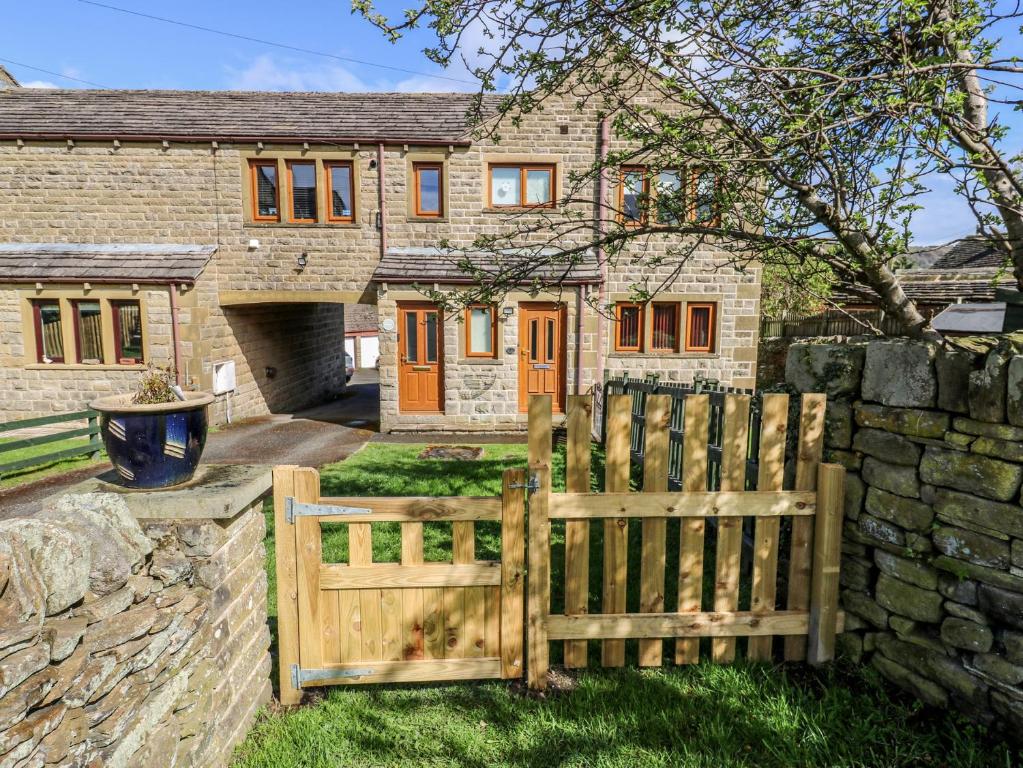 a wooden fence in front of a house at Moorview in Holmfirth