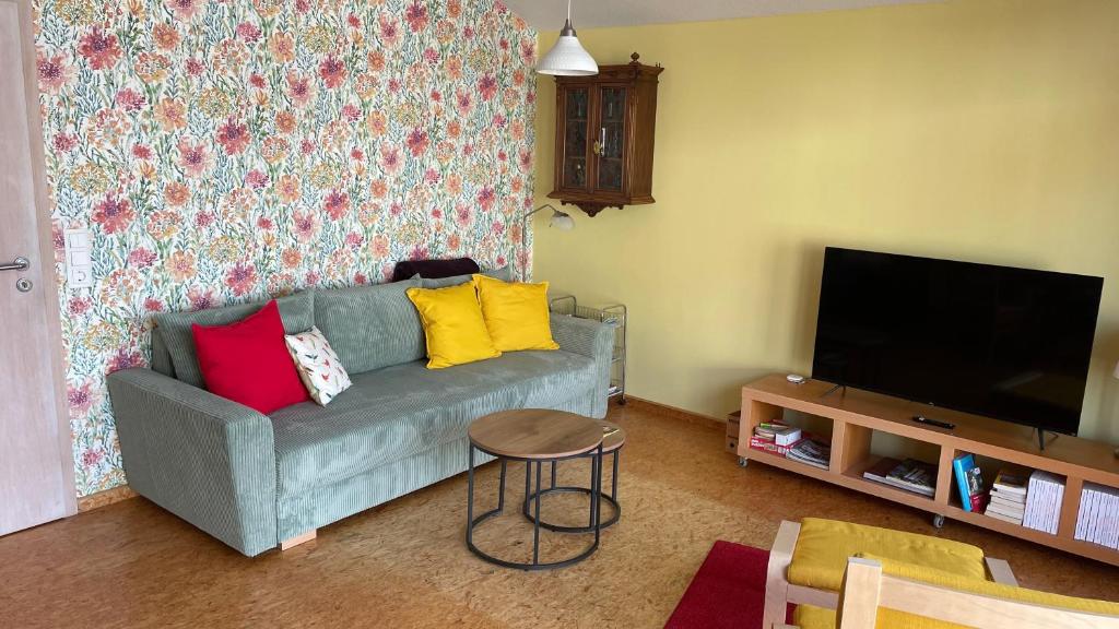 a living room with a couch and a television at Das Blaue Haus - jetzt mit Sauna in Pirmasens