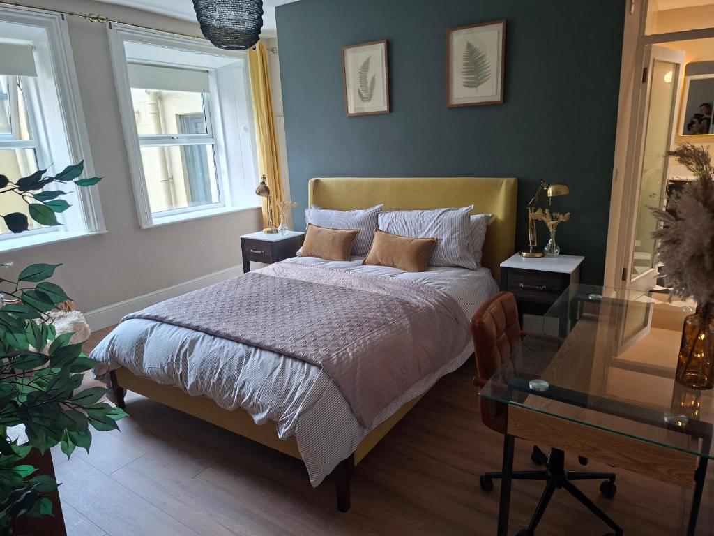 a bedroom with a bed and a glass table at Two bed Seaside retreat in Dublin