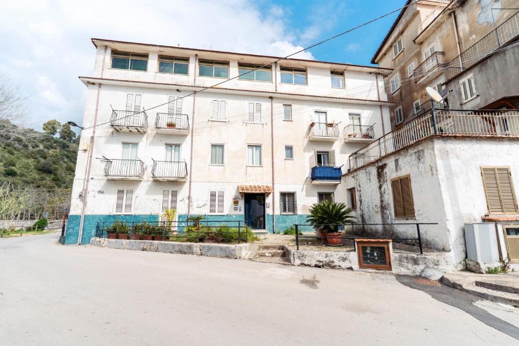 a large white building on the side of a street at B&B Morrocoy Beach in Marina di Camerota