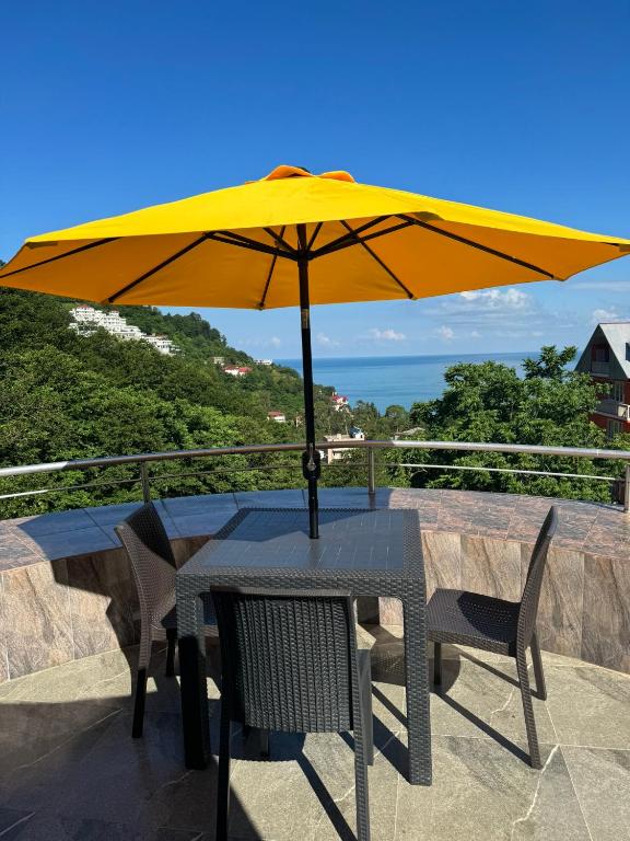 a yellow umbrella sitting on top of a table at Villa Royal Realm in Batumi