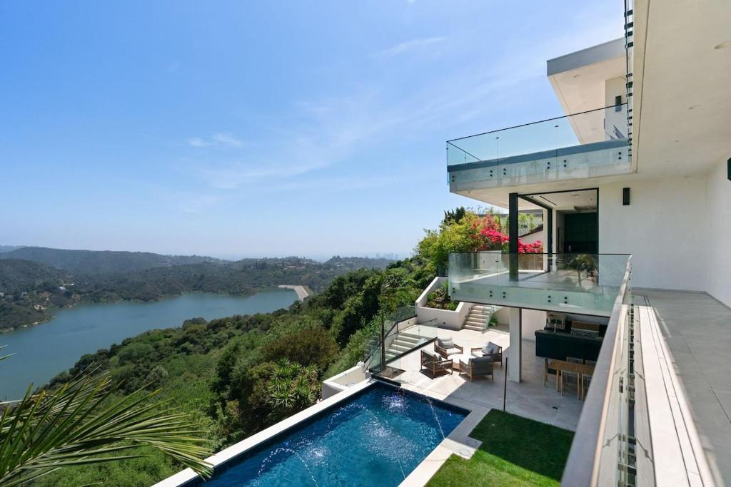 a house with a balcony with a swimming pool at Stradella Como in Beverly Glen