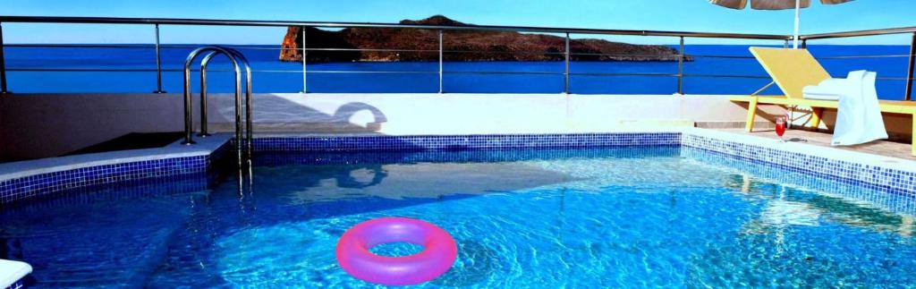 a swimming pool with a pink ball in the water at Sandy Point Villas Chania in Agia Marina Nea Kydonias