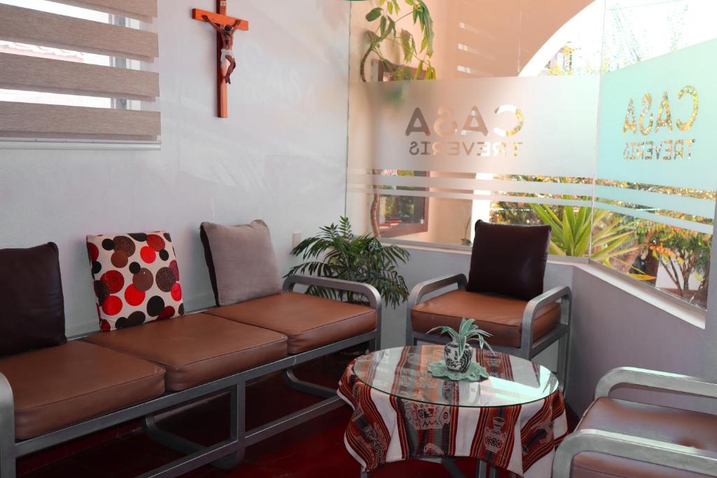a waiting room with a couch and chairs and a table at Casa Tréveris in Sucre