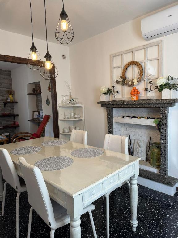 a dining room with a table and a fireplace at Il Vecchio Torchio in Perledo