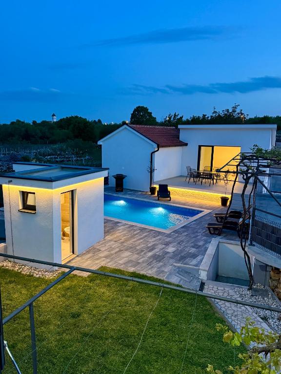 a backyard with a swimming pool and a house at Residence Stina in Široki Brijeg