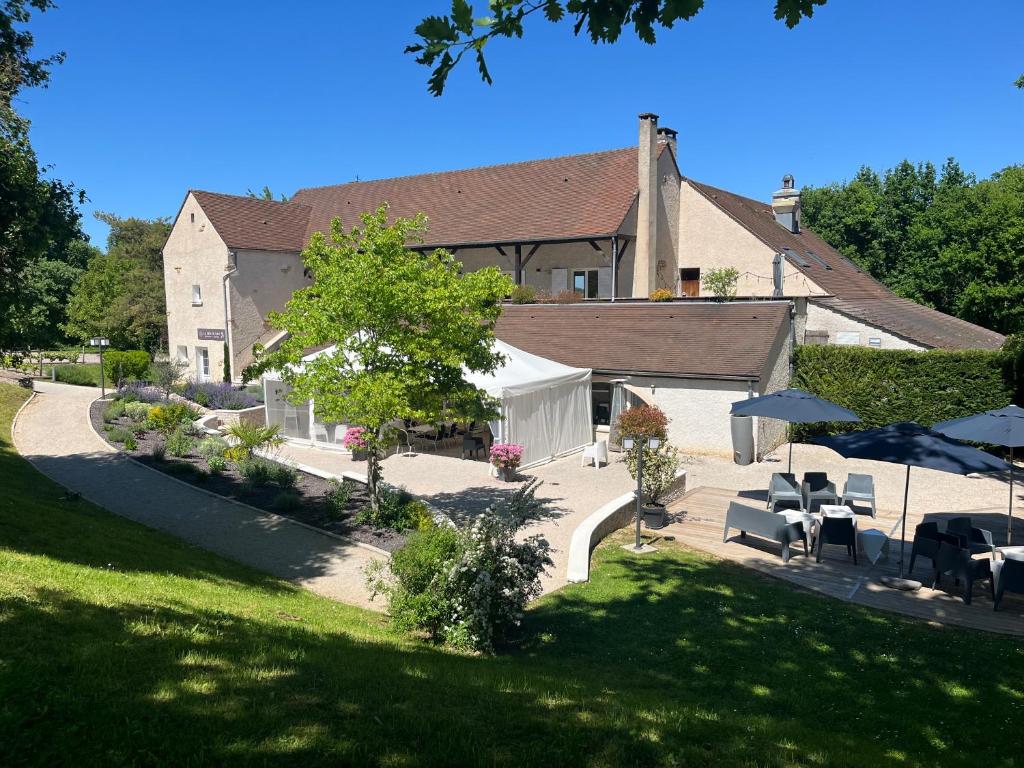 an aerial view of a building with tables and chairs at Le Carre Saint Pierre - Chambres d'hôtes in Marey-lès-Fussey