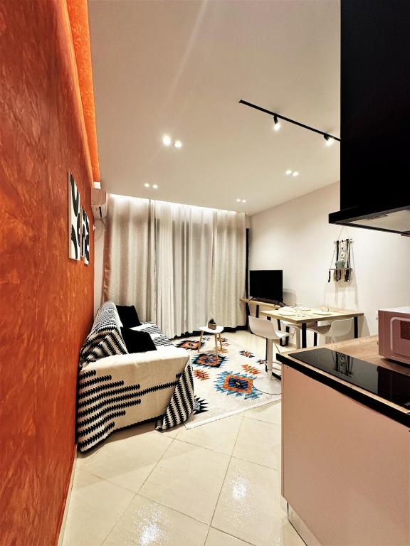 a living room with a couch and a table at DuoNest-BoHo Sunset in Tirana