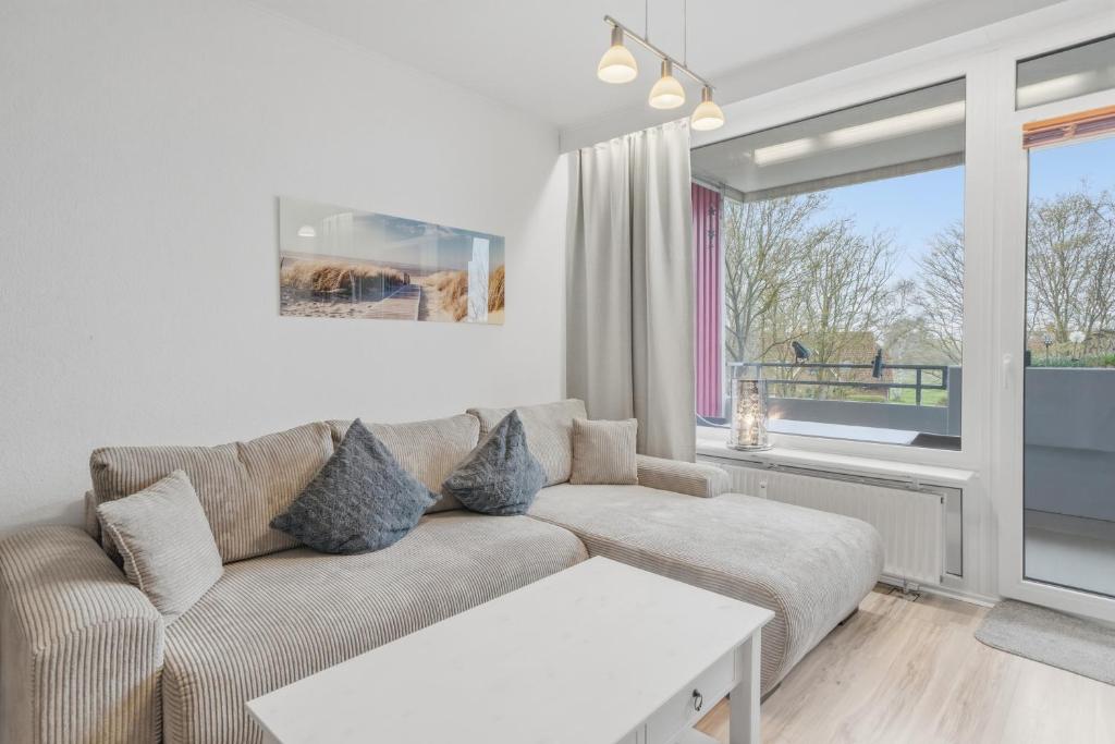 a living room with a couch and a window at Berolina C 106 in Dahme