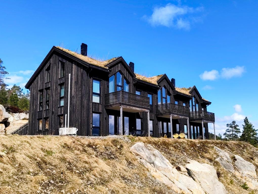 a wooden house on top of a hill at Eikerapen Panorama in Åseral