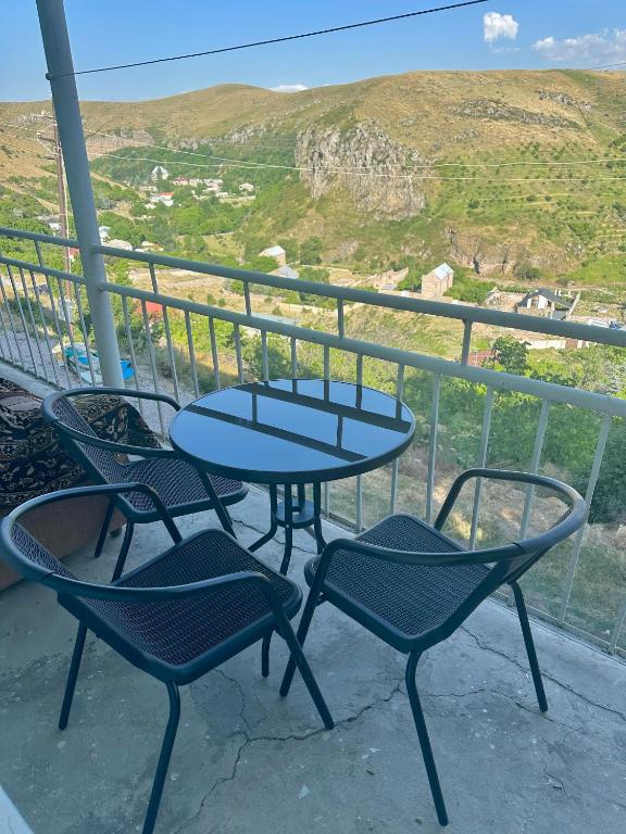 a table and chairs on a balcony with a view at 2 Floor House with big garden and Mountain View in Bjni in Bjni