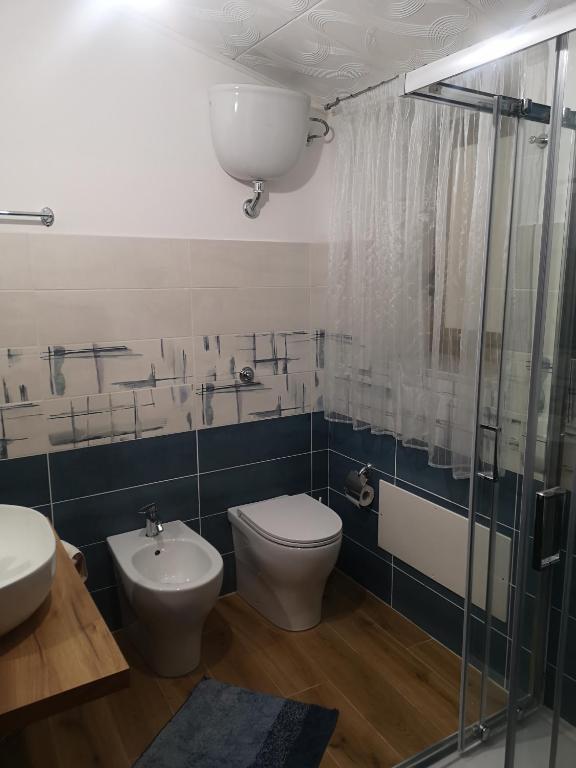 a bathroom with a toilet and a sink and a shower at Borgo Cipampini in Petralia Soprana