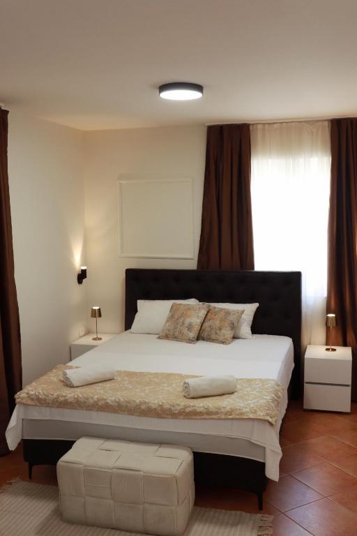 a bedroom with a large bed in a room at Stone Garden Residence in Budva