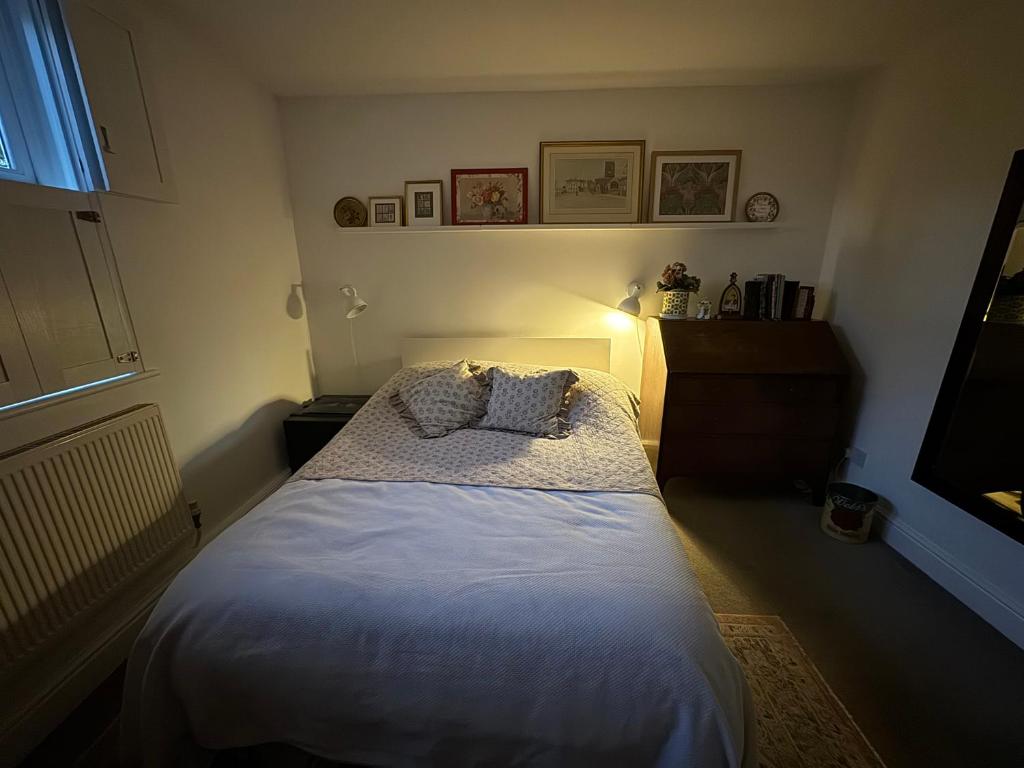 a bedroom with a bed with two pillows on it at 64 Cressingham Road in London