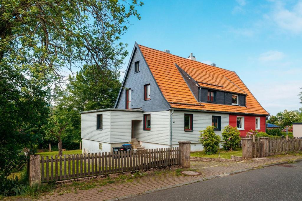 a small white house with an orange roof at Waldnest Braunlage in Braunlage