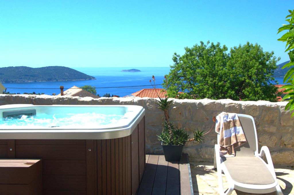 a bath tub sitting next to a stone wall at Heritage house Stone Orchard, near Dubrovnik in Orasac