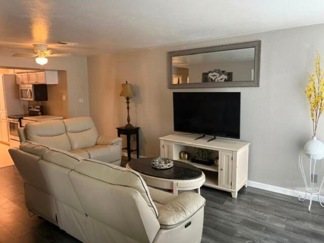 a living room with two couches and a flat screen tv at Woodrow St in Arlington