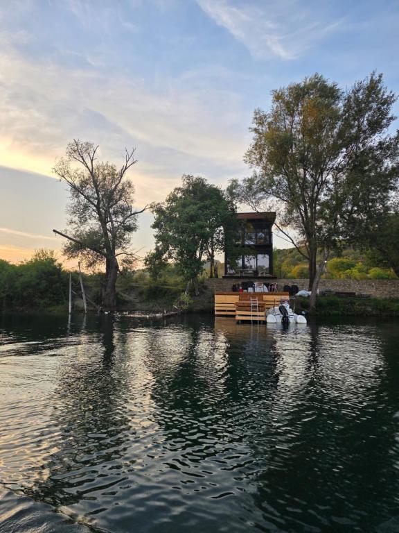a house in the middle of a body of water at Hoota Cottage Bojana River in Ulcinj