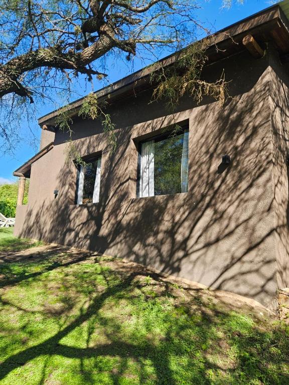 a house with two windows on the side of it at Cabañas Altos de San Blas 3 in Pueblito
