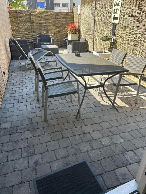 a picnic table and chairs on a brick patio at Ô’pti Cavens in Malmedy