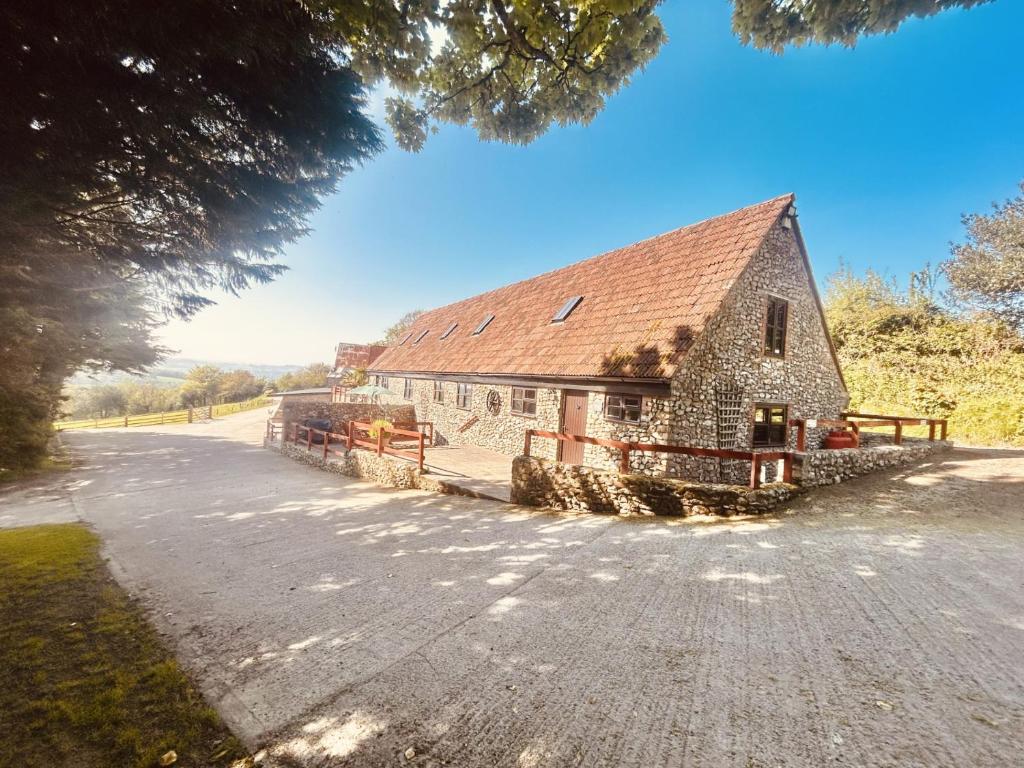 an old stone building on the side of a road at Cider House - near Lyme Regis in Axminster