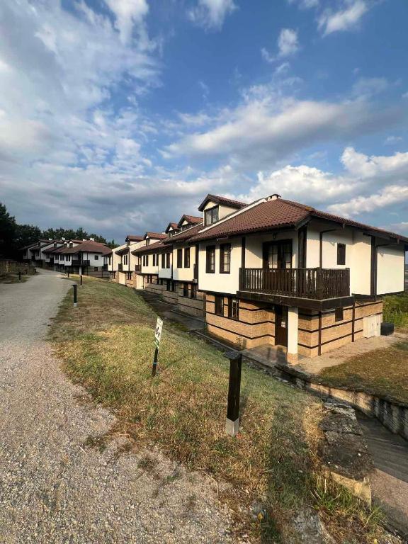 a row of houses on the side of a road at Къща за гости Белора in Dryanovo