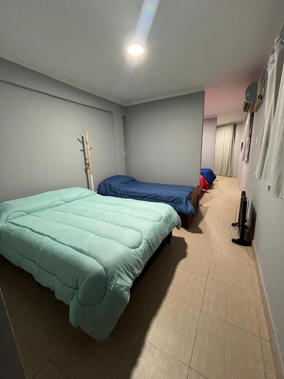 a bedroom with two beds in a room at Hospedaje Don Antonio 1 in Tinogasta