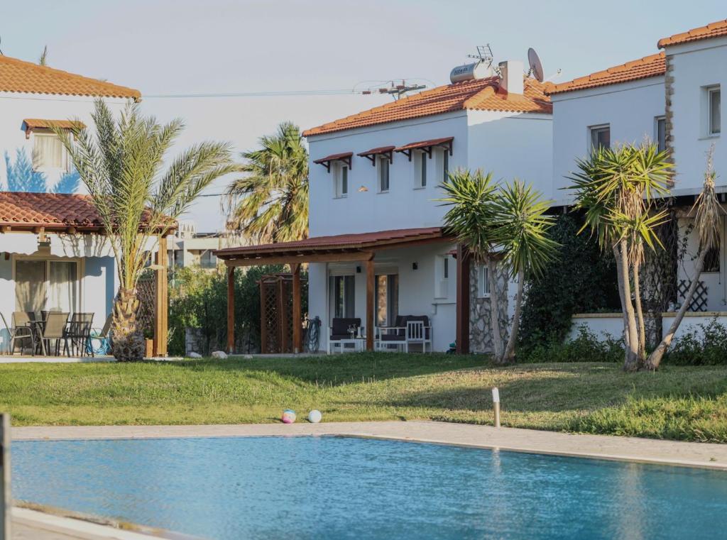 a house with a swimming pool in front of a house at Villa Christalia in Kolymbia