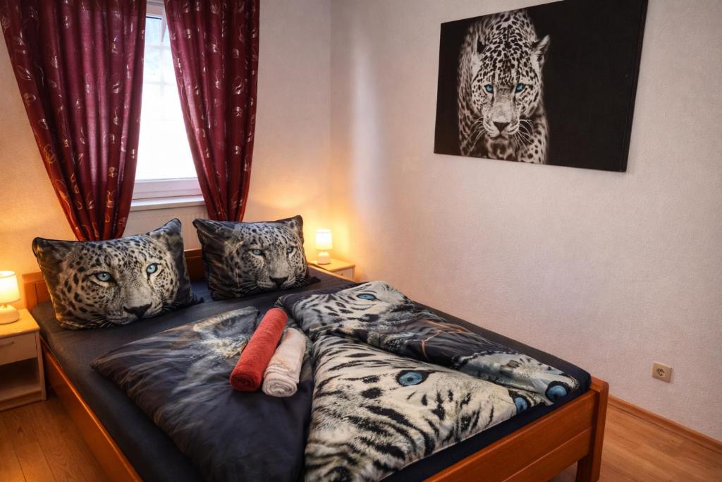 a bedroom with a bed with animal pillows and a window at Holiday Rhein 4 in Boppard