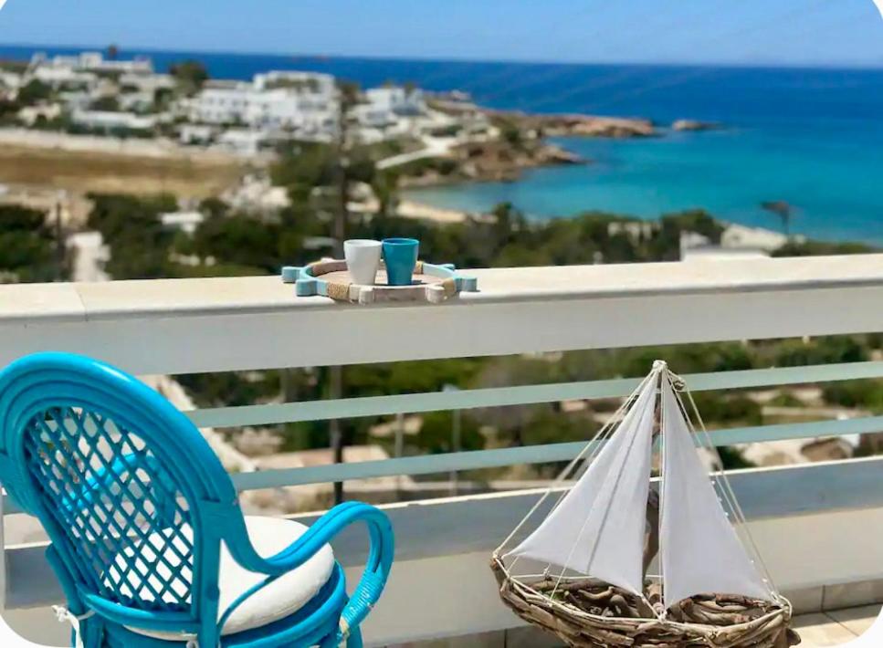 a blue chair sitting on a balcony with a bag at Mare Monte Suites 1 in Parasporos