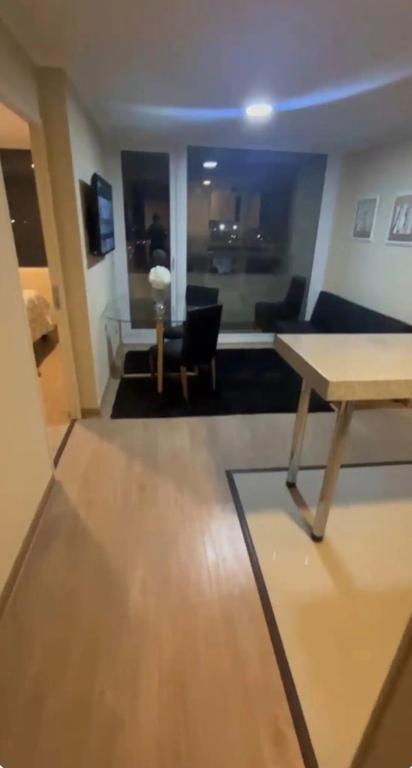 a living room with a table and a couch at Laurel de oro in Chillán