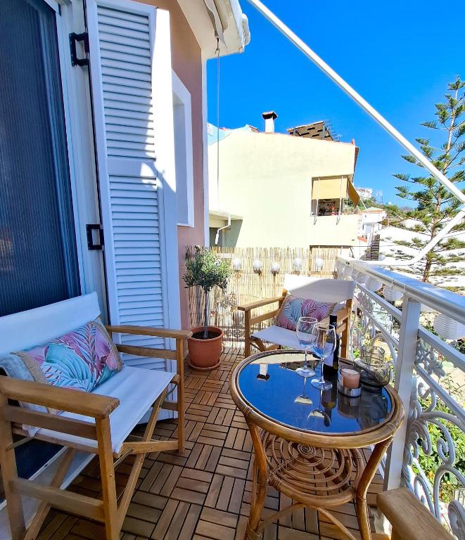 a patio with chairs and a table on a balcony at Blue Sky Apartments Pythagorion in Pythagoreio