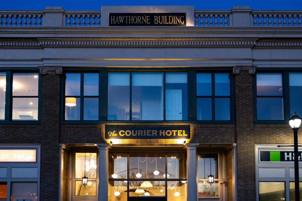 a store front of a building with a sign on it at The Courier Hotel in Salem