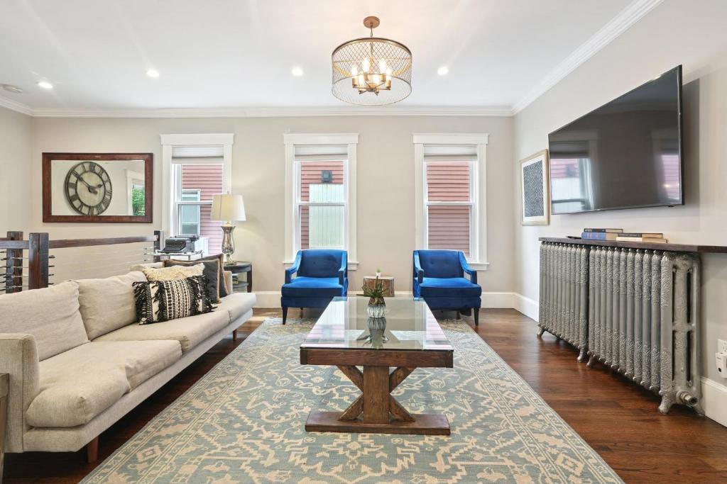 a living room with a couch and a table at Boston Escape Near T in Boston