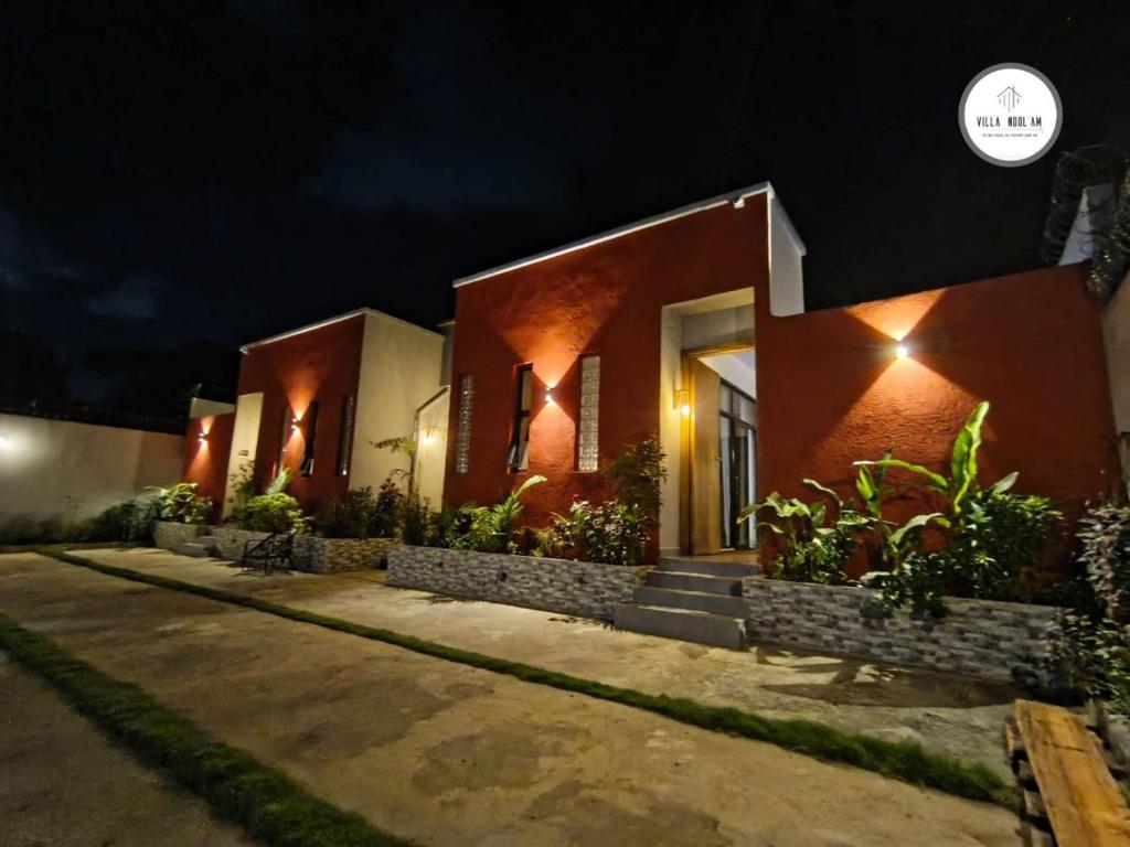 a house with lights on the side of it at night at Villa NDOL'AM in Ebomé
