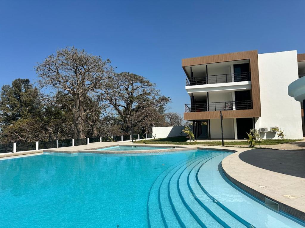 a large swimming pool in front of a building at Tanji Cliffs in Tanji