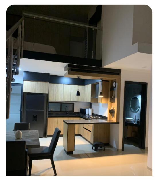 a kitchen with a table and a dining room at Complejo Las Flores departamento 3 in Durango