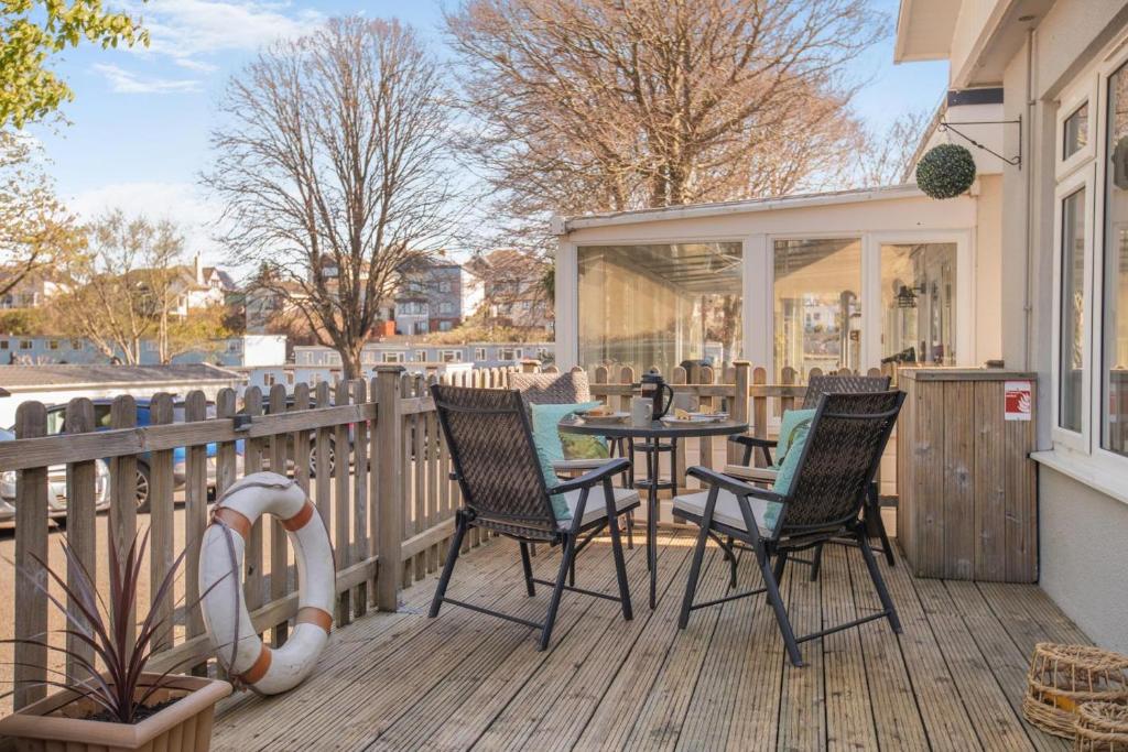 a patio with chairs and a table on a deck at 2 Bed in Brixham oc-57244 in Brixham