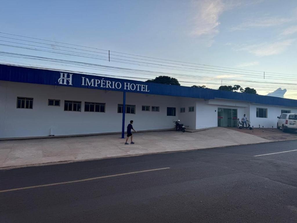 a person standing in front of a building at Império Hotel in Costa Rica