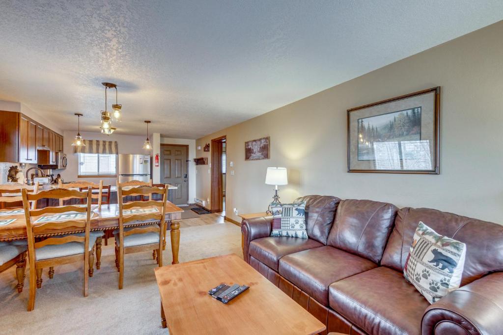 a living room with a couch and a table at Winter Park Condo w/ Pool + Ski Shuttle Access! in Winter Park