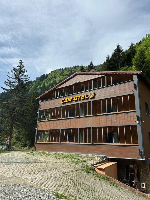 a large building with a sign on the side of it at Çam Otel 2 in Uzungöl