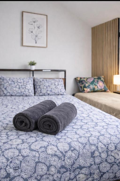 a bed with two rolled up towels on it at Superbe studio top emplacement in Villeneuve-Saint-Georges