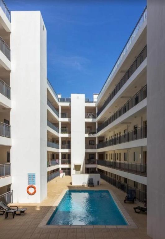an empty apartment building with a swimming pool at Island Dream Apartment in Olhão