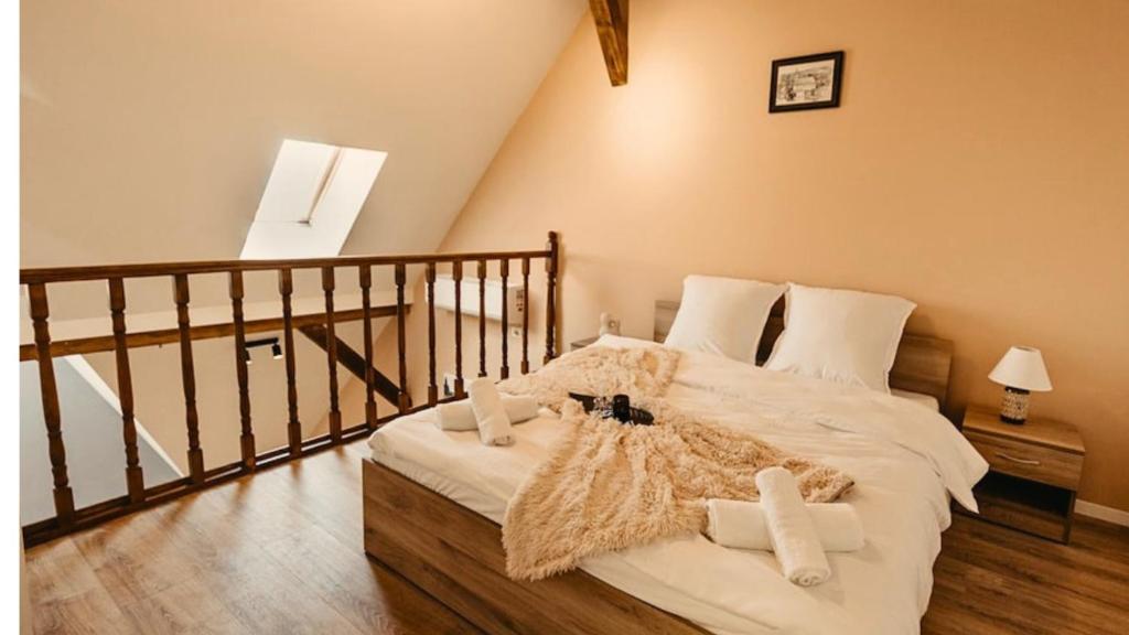 a bedroom with a large bed with white sheets at OLD TOWN Palatul Agoston Galgon in Timişoara