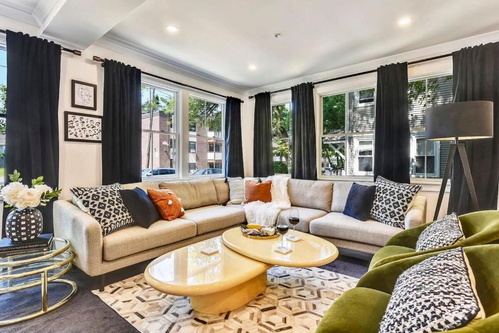 a living room with a couch and a table at Luxe Boston Condo Near T in Boston