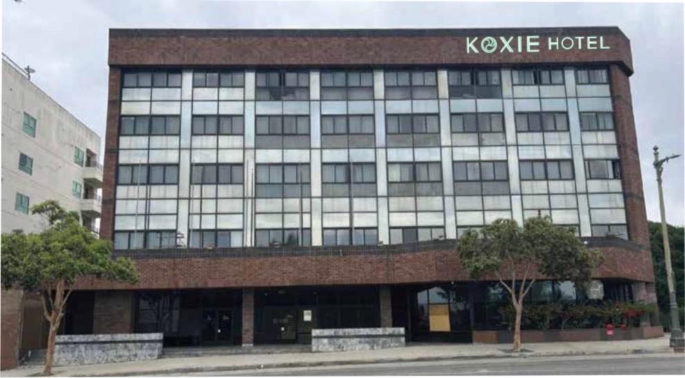 a large building with a sign on top of it at Hotel Koxie in Los Angeles