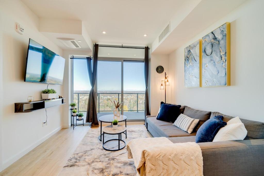 a living room with a couch and a table at Stylish Open Concept Suite in Central KW in Kitchener