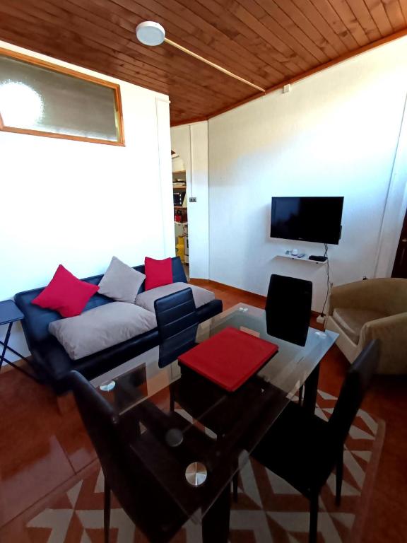 a living room with a couch and a table at Departamento Lido Central in El Cerrillo